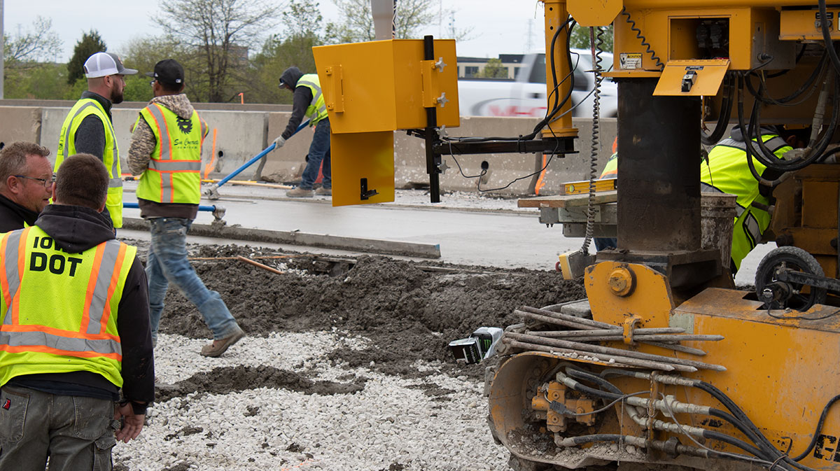 A finishing crew work concrete used for stringless paving in Iowa.